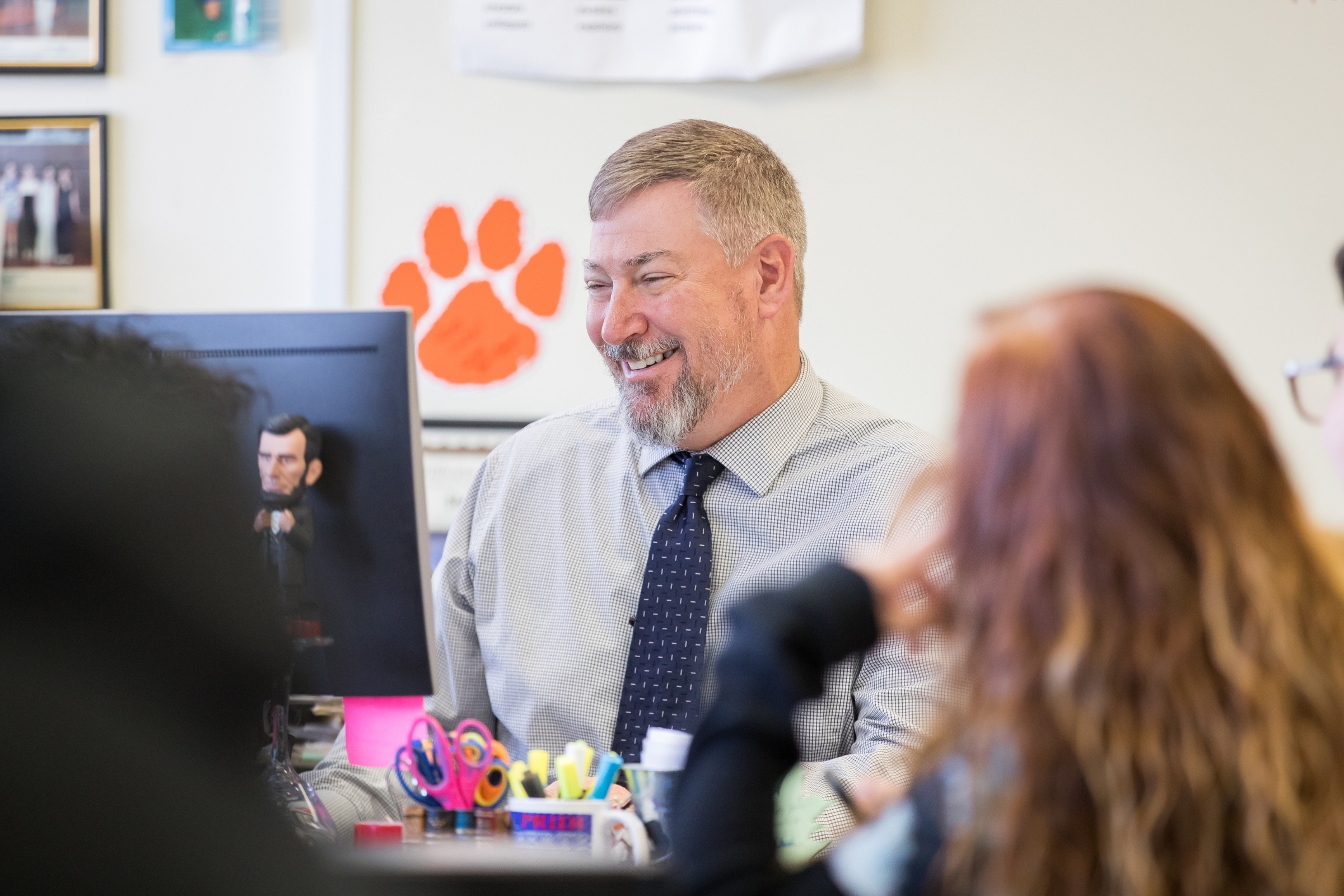 A teacher sitting at his desk