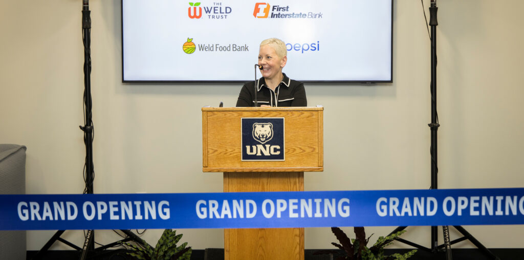 Jenna Finley standing at a podium talking to a crowd