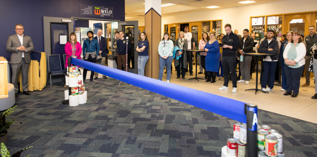 A crowd behind a giant ribbon