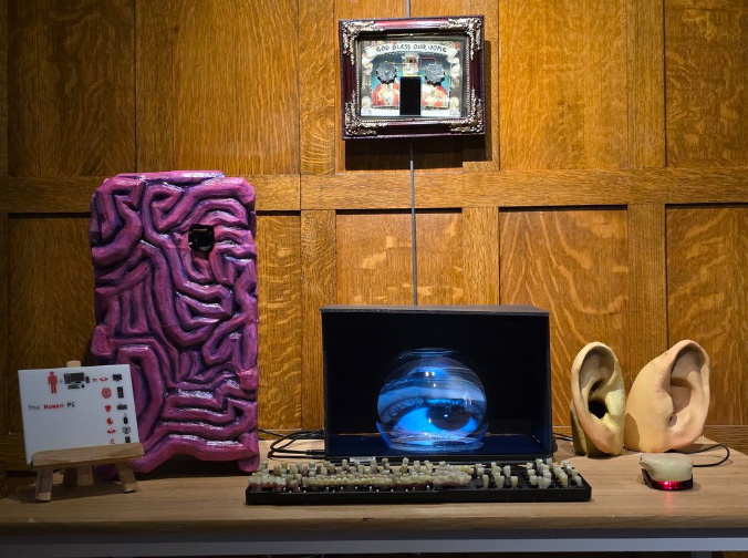 A physical art piece of fake human body parts as a computer.