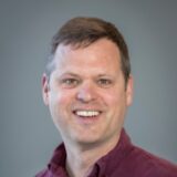 A headshot of David Hulac smiling