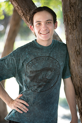 Dylan Roseman leaning against a tree.