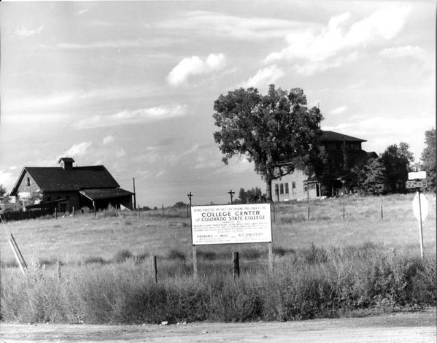 A black and white photo of an old farmstead.
