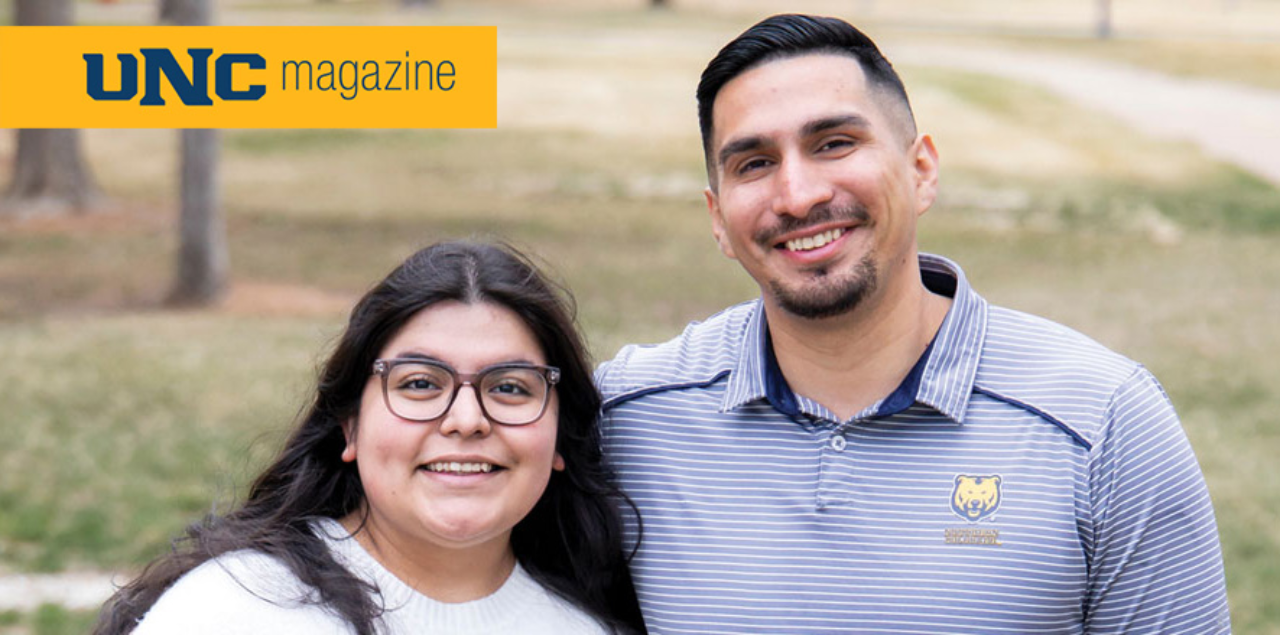 Two students posing and smiling for the camera, with the UNC magazine logo in the upper left corner of the picture.