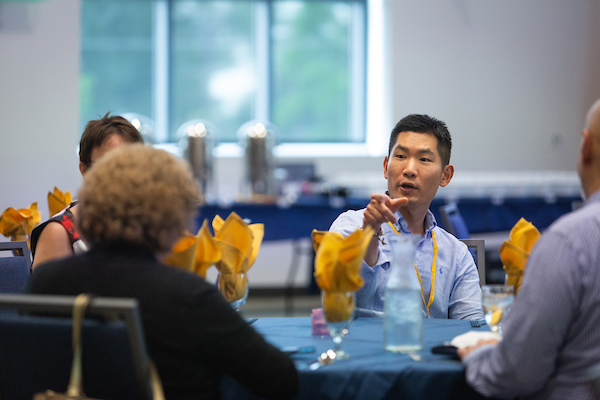 Small group conversing during a learning conference