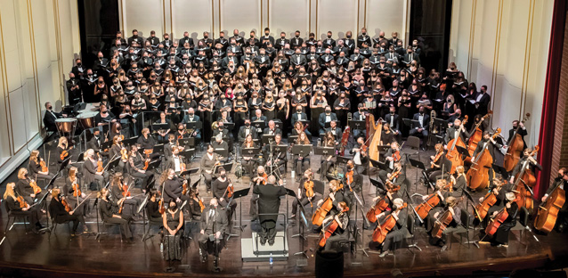 A large orchestra performing on stage