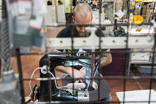 A man working on the inside of a hat