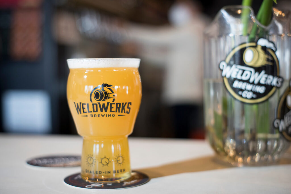 A full glass of beer that has Weld Works on it