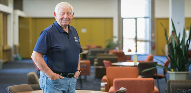 Kent Trompeter standing and smiling inside a library