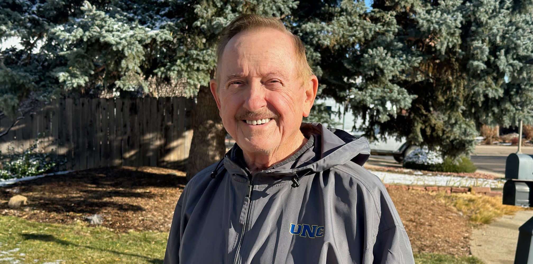 Larry Blakenship wearing a UNC jacket and smiling outside