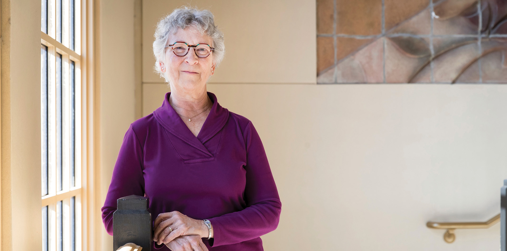 Liz Kissell smiling in a building near a window