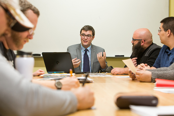 Man in suit leads discussion in meeting