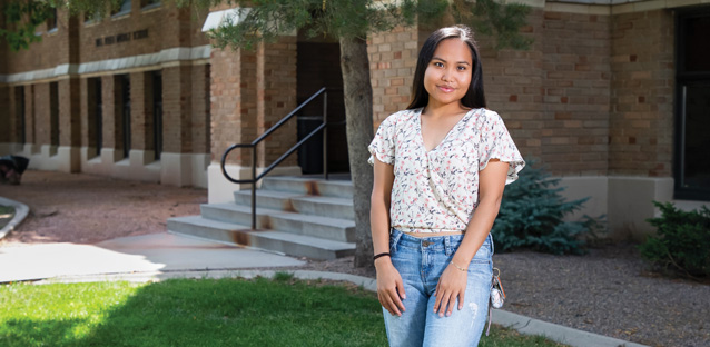 Meh Sod Paw standing outside of a building smiling