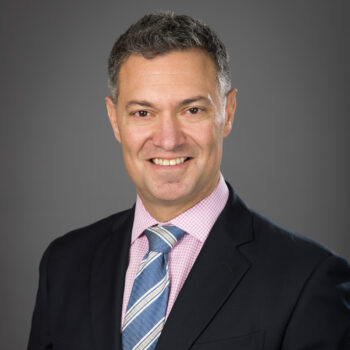 Headshot of Michael Ian Cohen wearing a suit