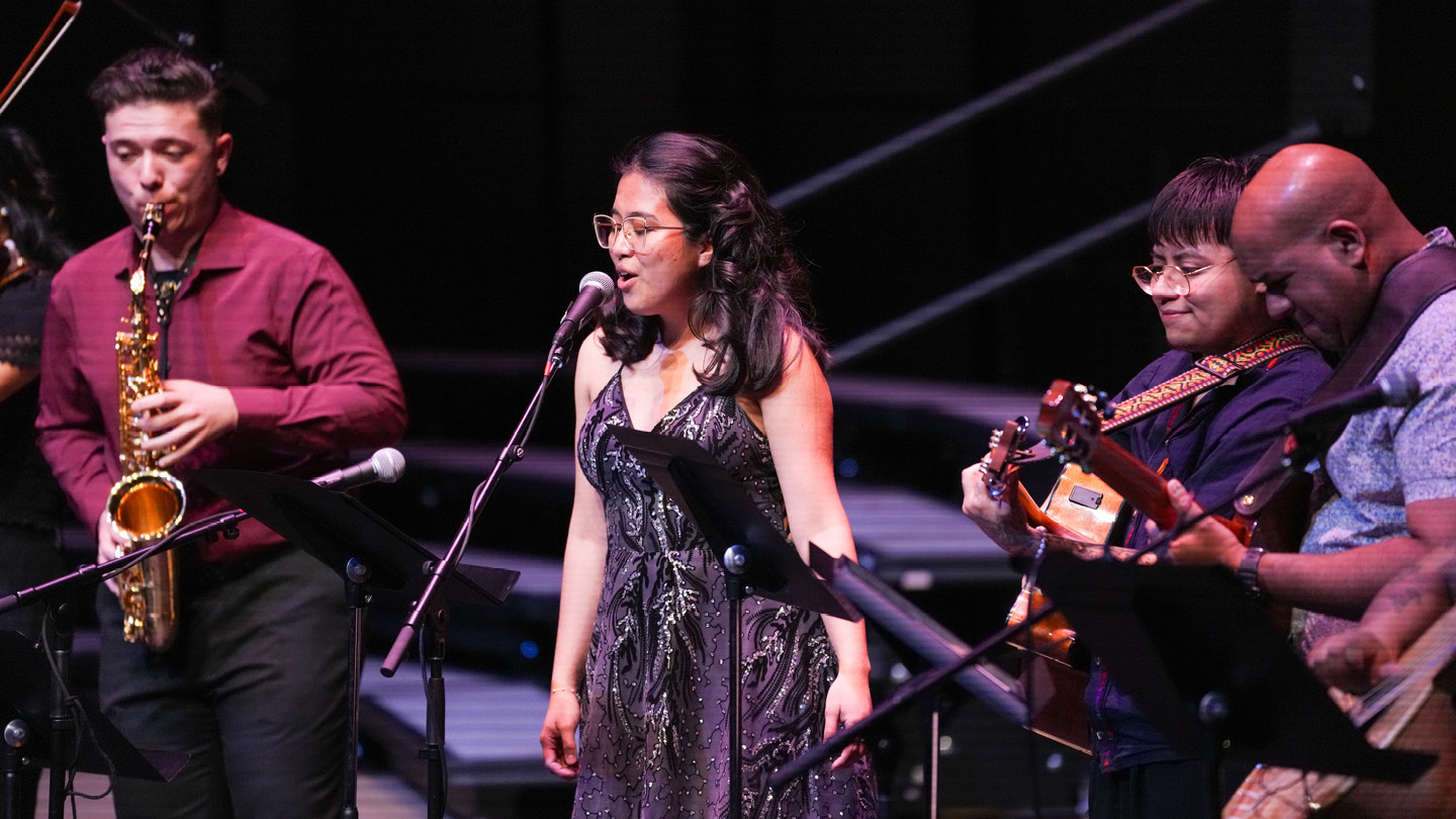 Vocalist and instrumentalists from Latin Beat Ensemble performing in Campus Commons Performance Hall.