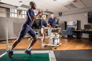 Athlete running with sensors to measure body movements