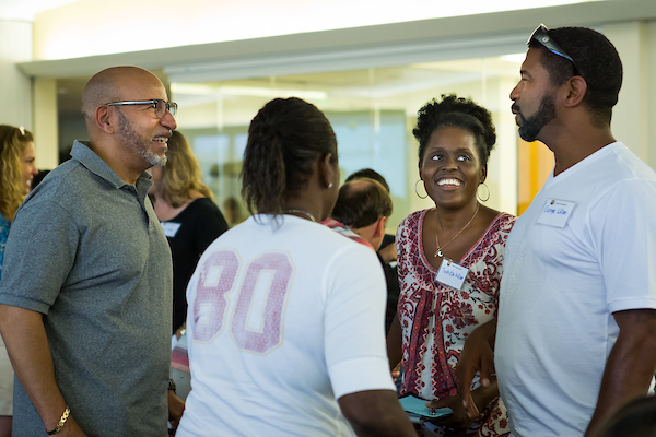 Parents chat with one another at a university event.