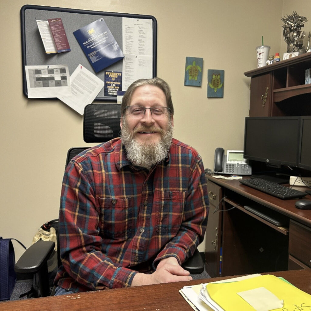 Ryan Darling sitting at his desk smiling