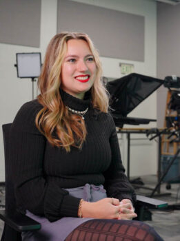 Sophia Tavanello smiling looking away from the camera.