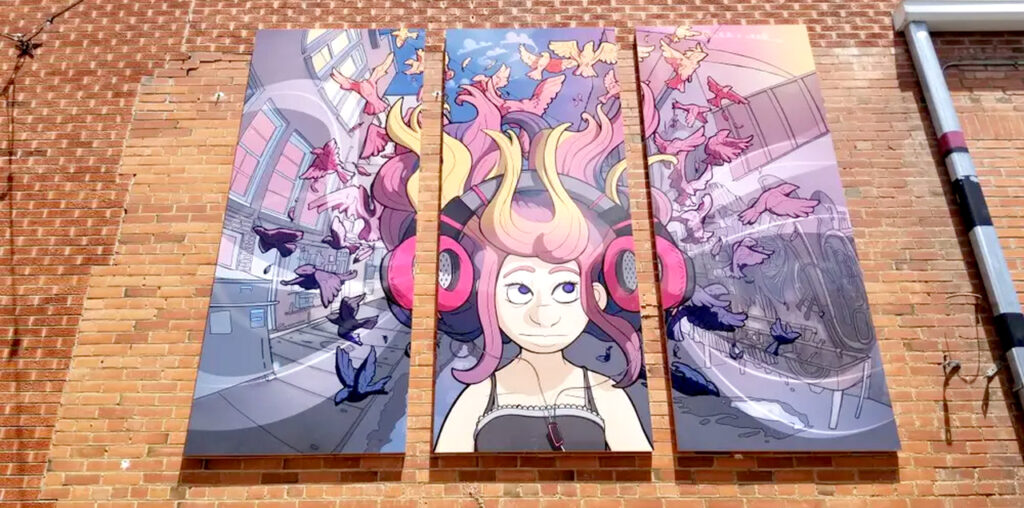 Three paintings on the side of a building that combine to form a picture of a girl with pink hair.