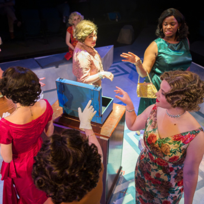 Several female actors speaking in a circle in the play This Restless House.