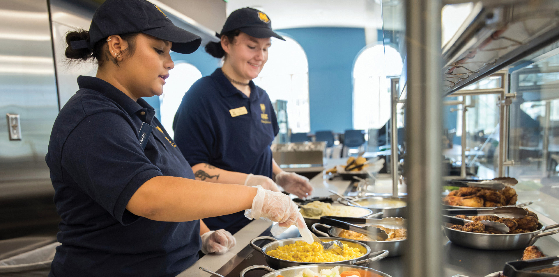 Two workers cooking in a kitchen