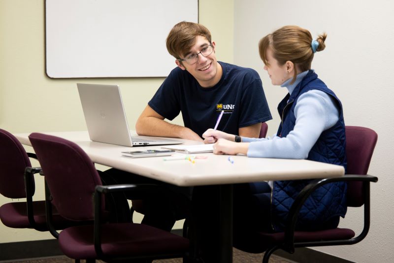 Student with tutor at a table
