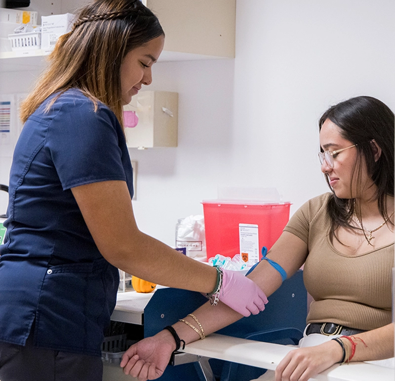Student having blood drawn at the university health clinic.