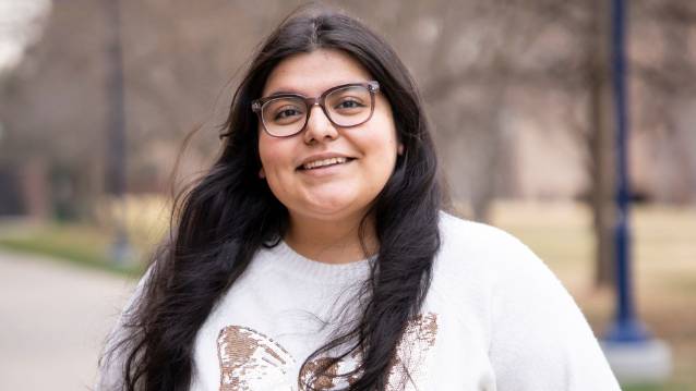 UNC student Vianney Ocampo smiling at the camera in a park.