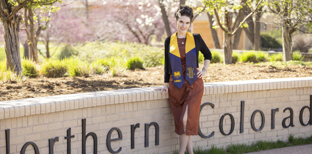 Victoria Rule standing next to a University of Northern Colorado brick sign.