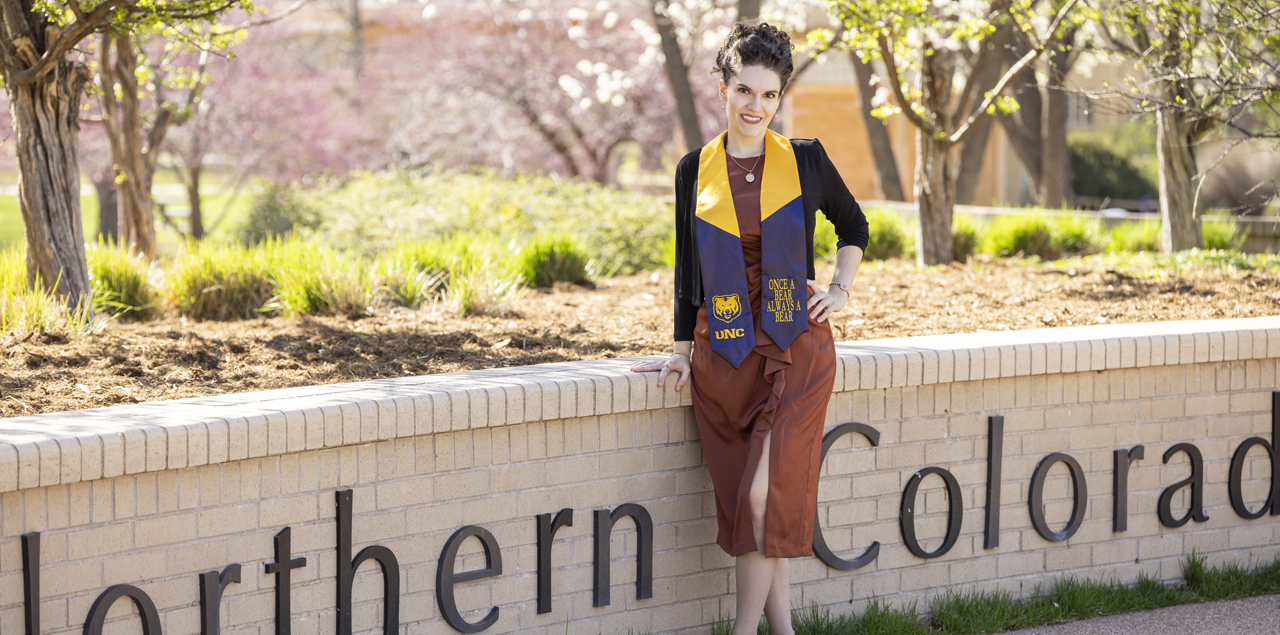 Victoria Rule standing next to a University of Northern Colorado brick sign.