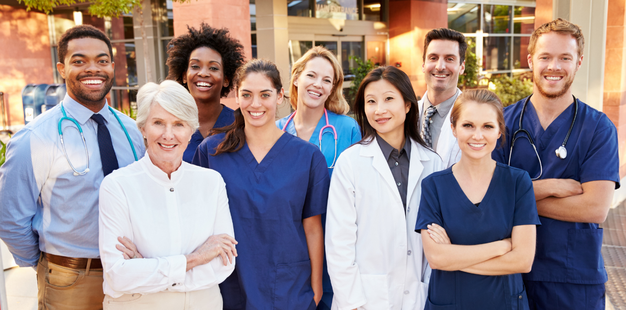 A group of medical professionals smiling at the camera.