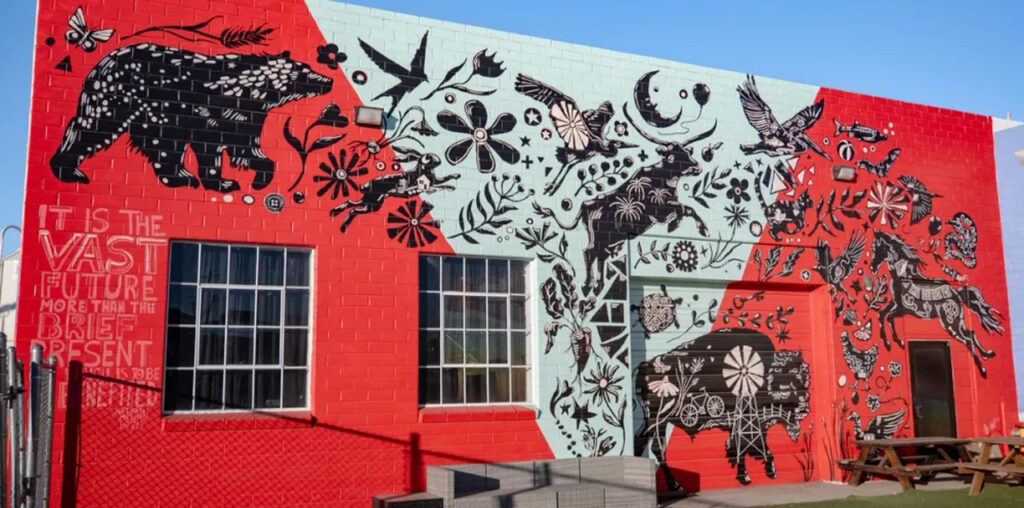 A red and white mural with lots of animals.