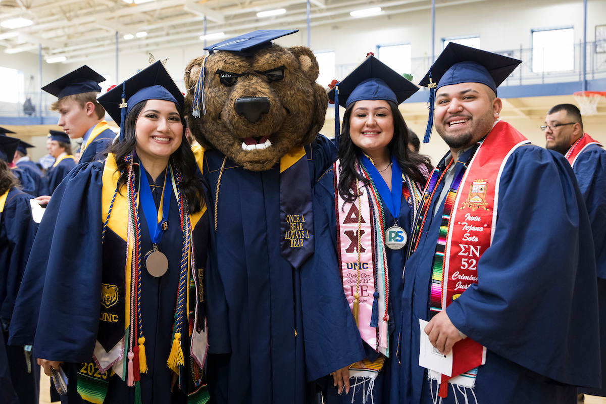 Klaws with students at graduation.