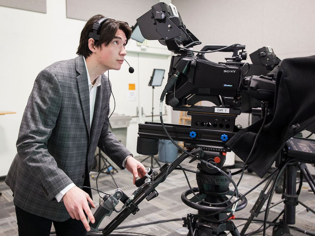 Student operating a camera during a Bear News show.