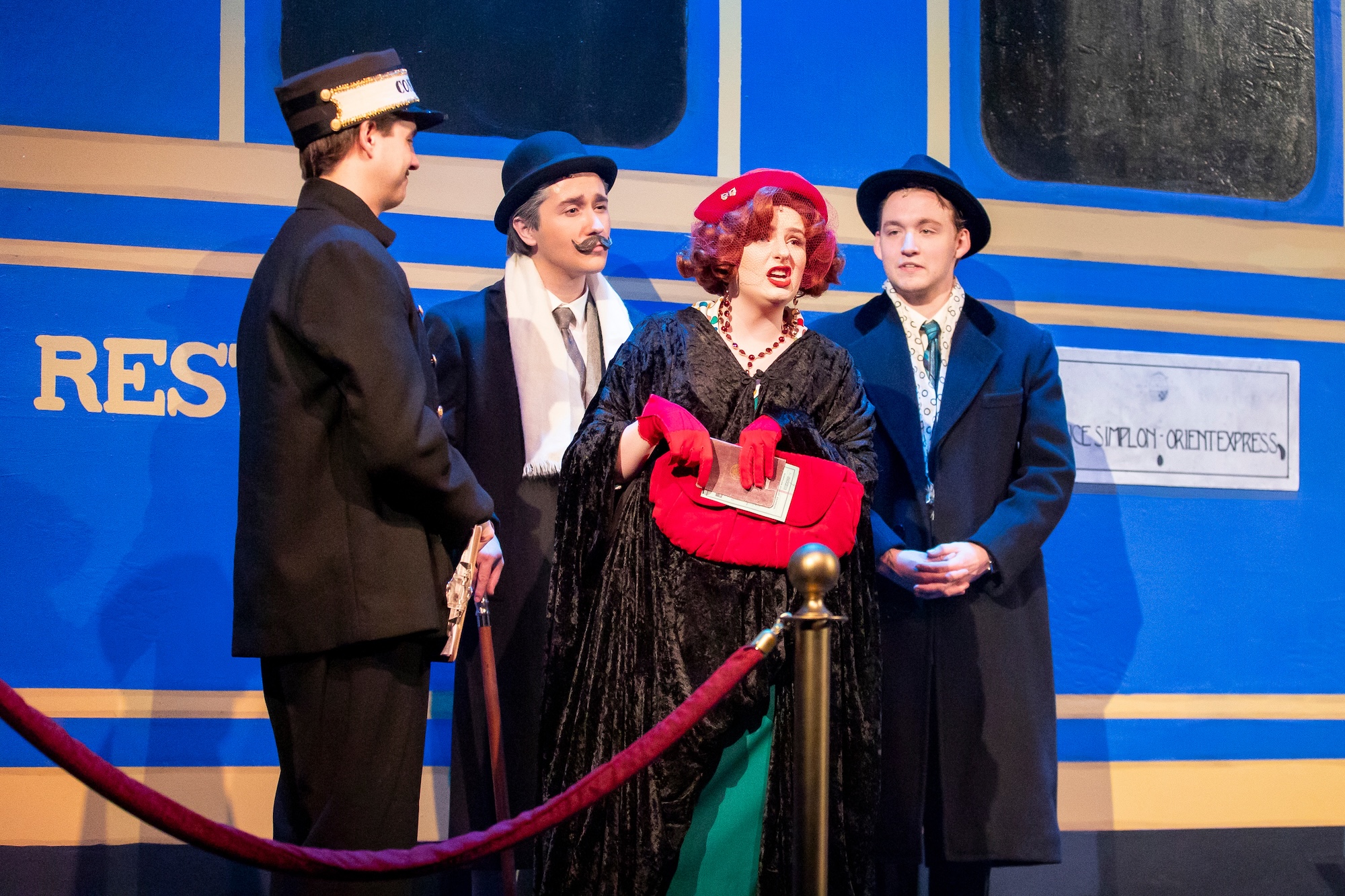 4 characters in front of the train in Murder on the Orient Express play.