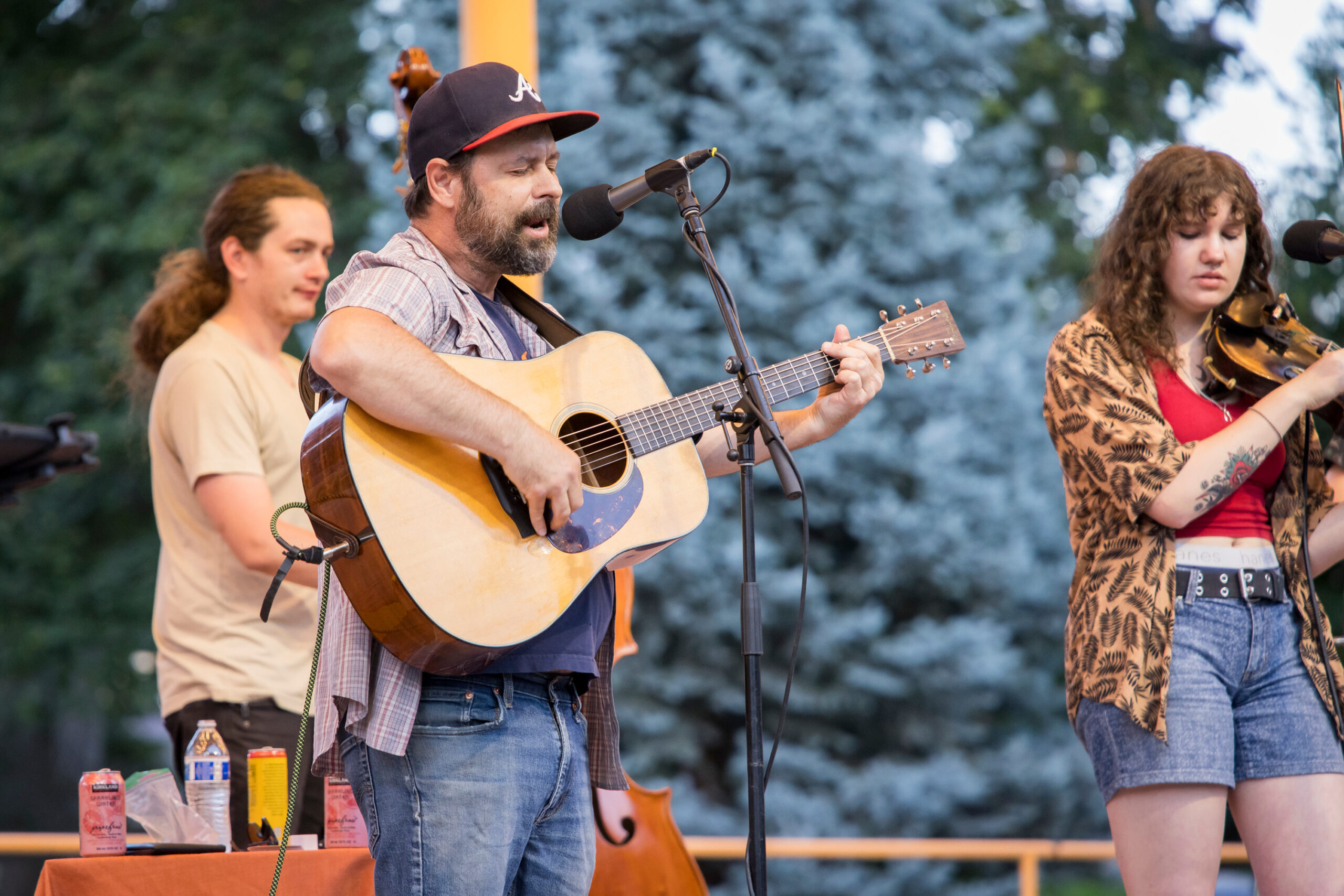 Lead singer of High Lonesome playing guitar at Concerts Under the Stars.