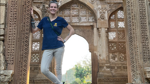 Miranda Bermudez in India standing in front of a building in India.
