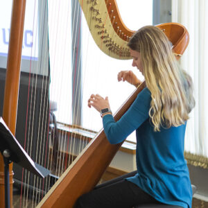 Honors student performing on Harp
