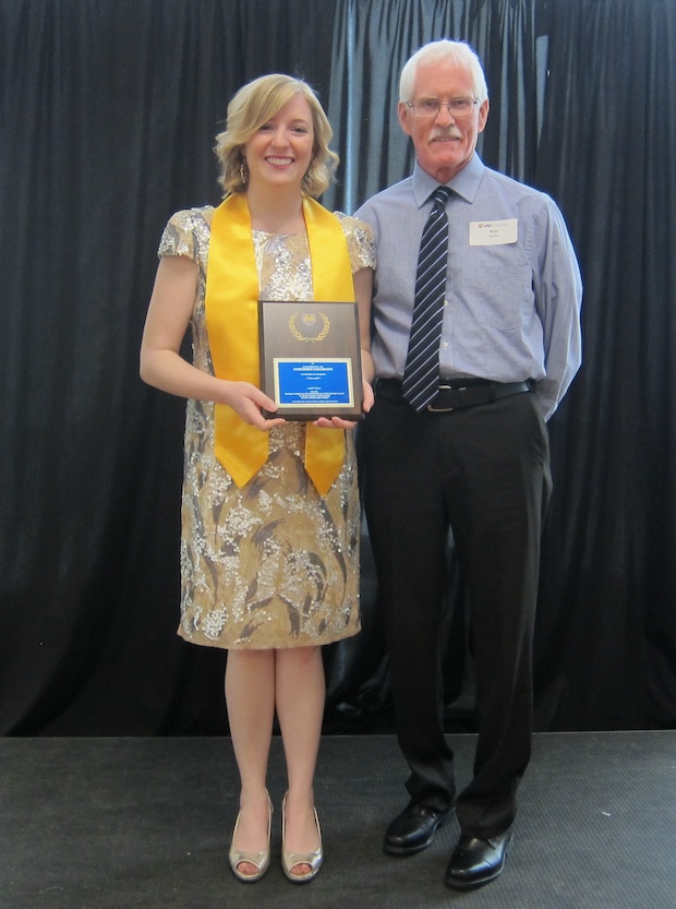 Photo of Maddie Azari standing with Honors donor, Dr. Ron Edgerton. Maddie is holding the Becky Edgerton Memorial Award plaque