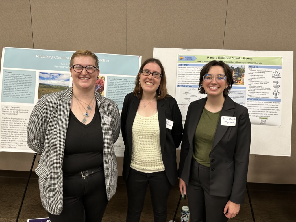 Three Anthropology Students presenting their research at a professional conference.