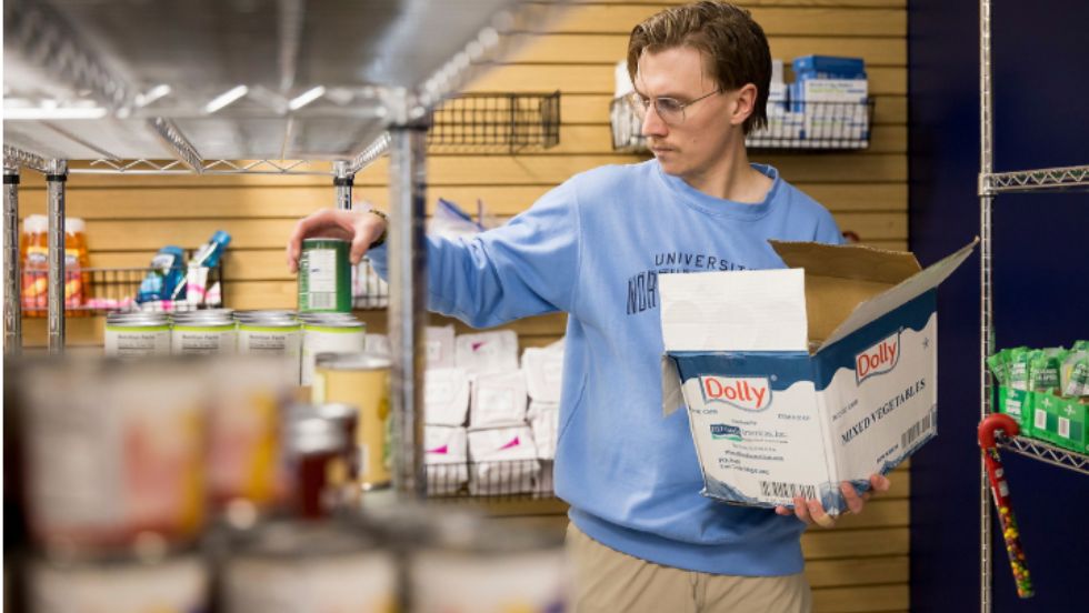 A student restocks shelves.