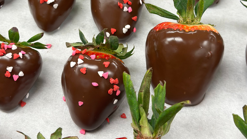 Chocolate covered strawberries sit on a tray.