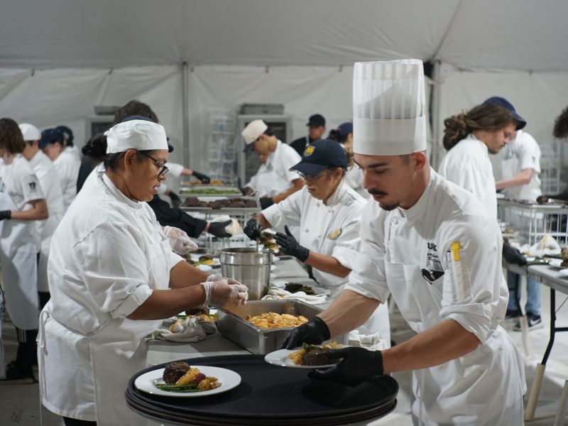 The catering staff working hard to prep beautiful plates of food