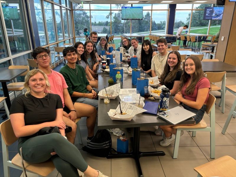 Daniels scholars smile for a photo during a meeting in the University Center.