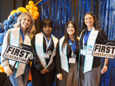First generation scholarship recipients pose for a photo at an event