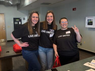 A group of PLP volunteers pose for a photo at an event.