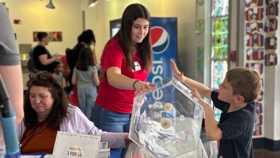 A PLP scholar volunteers at an event.