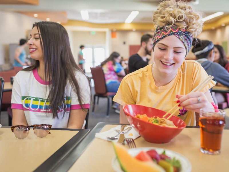Two students enjoy a meal in Holmes Dining Hall