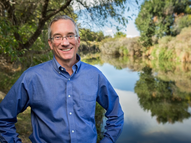 UNC Economics professor Mark Eiswerth standing by a lake
